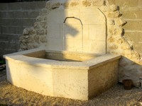 Old stone fountain of reconstituted limestone