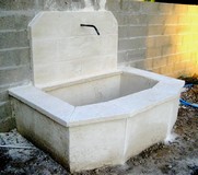 Old stone fountain of reconstituted limestone